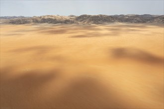 Sandy desert plain and bare mountain ranges