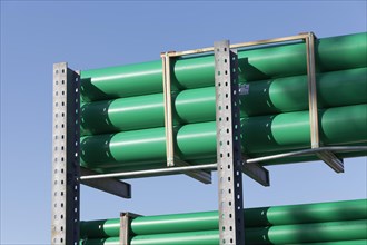 Green plastic sewage pipes in a warehouse for building material