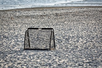 Football goal in the sand