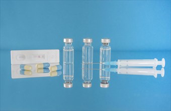 Vaccine bottles and syringe