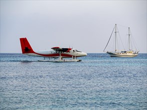 Seaplane landing in a lagoon of a Maldives island