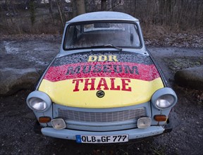 Advertisement for the GDR Museum in Thale on a Trabant in the colours black
