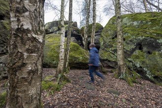 Boy running through rock labyrinth Langenhennersdorf
