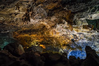 Colourfully illuminated areas of the Cueva de los Verdes