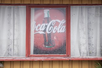 Old advertising sign for Coca-Cola in window