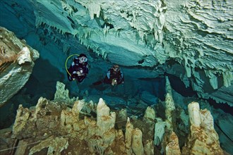 Scuba diver in easy-to-dive freshwater stalactite cave like Cenote