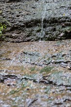 Water flowing down steep rock face
