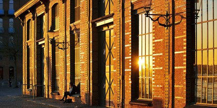 Shore-side facade of the Fischauktionshalle Hamburg-Altona at sunset