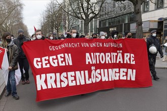 Demonstrators of the Left Party carry banner Against authoritarian crisis solutions
