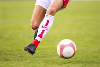 Legs of a running football player