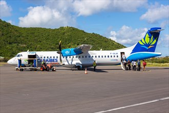 Passengers boarding an Air Caraibes Simply ATR 72-500 with registration F-OIJK at Saint Martin airport
