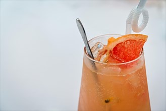 Grapefruit juice in a glass with white background