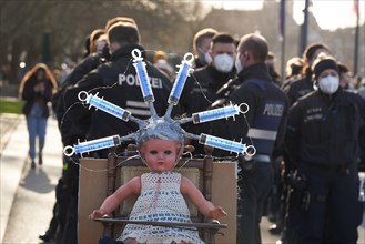 A doll with syringes is presented at a demonstration against the government's corona measures. Koblenz