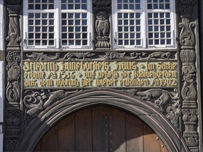 Lettering and wood carvings above the entrance gate of Huneborstel's House