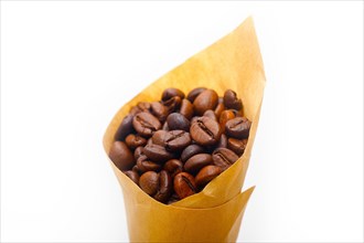 Espresso coffee beans on a paper cone cornucopia over white background