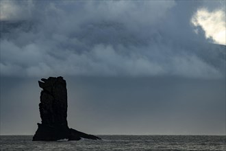 North Atlantic with rock needle and cloudy sky