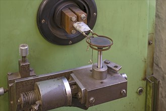 Copper coil of an induction hardening machine in a historical valve factory