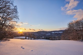 Sunset over a field covered with snow near Wiesent
