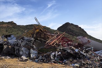 Scrap piles in front of mountains