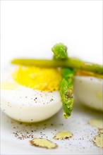 Boiled fresh green asparagus and eggs with extra virgin olive oil