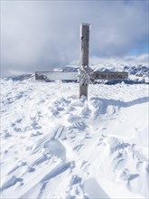 Snow-covered summit cross