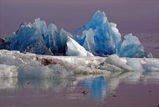 Blue iceberg reflected in the water