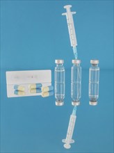 Vaccine bottles and syringe