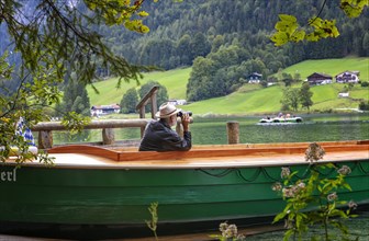 Ferryman of the Annerl ferry station at Hintersee keeps an eye out for passengers
