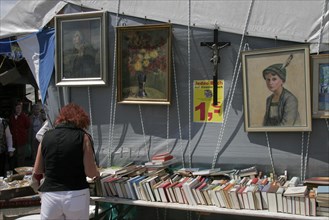 Woman from behind at bookstall at flea market