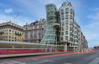 Moving tram in front of the dancing house