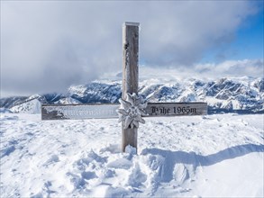Snow-covered summit cross
