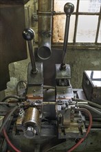 Detailed view of a welding machine in a former valve factory