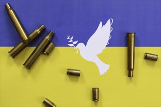 Ukrainian flag with peace dove and cartridge cases