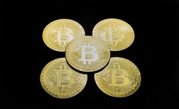 Bitcoin BTC crypto currency gold coins on black background