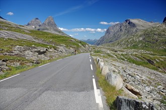 Narrow road leads through barren mountain landscape