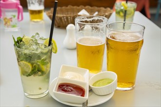Glass of lemonade with lime and mint with Mauritian chilled beer