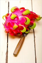 Fresh thai purple dragon fruit over white rustic table