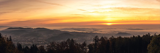 Panorama of Graz city covered in fog on autumn morning during sunrise
