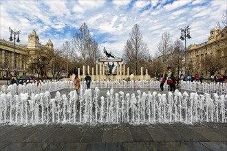 Visitors at the fountain in front of controversial monument to the victims of the German occupation