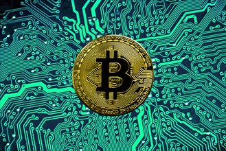 Bitcoin BTC crypto currency gold coins on a mainboard