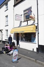 People sitting outside Pieseas chippy chip shop. Harwich