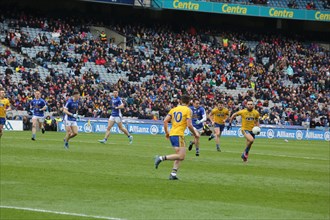 Gaelic football player with ball in hand during match in Dublin