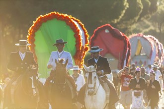 Pilgrims in traditional attire with horses and wagons on their way to El Rocio for the yearly Romeria of El Rocio
