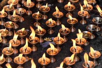 Worshippers light butter lamps