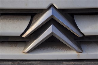 Citroeen car logo on dirty radiator grille