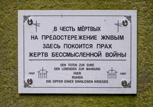 Memorial sign in Russian and German at the cemetery for Soviet prisoners of war from World War 2