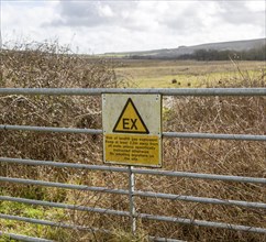 Sign warning of danger of gas explosion at landfill site
