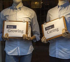Positive messages during Covid coronavirus lockdown held by mannequins in shop window
