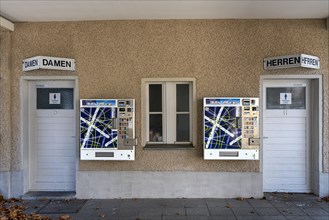 Cigarette vending machines next to public toilet facilities