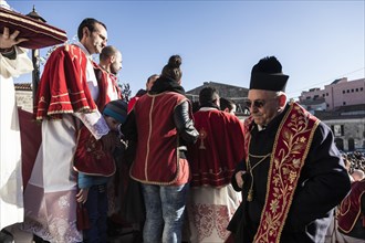 The Parish Priest walking up the stairs of the Cathedral during the Good Friday ceremony in the village of Mussomeli